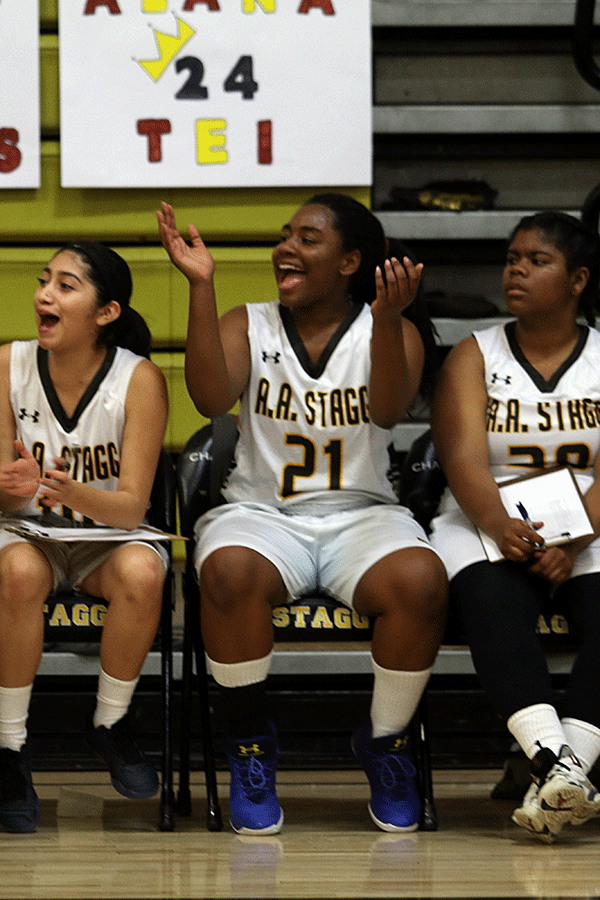 Junior Montserrat Reteguin, junior Phyllis Strother, and senior Kochia Anderson sit anxiously on the bench cheering on their team during the final league game against Chavez. Stagg lost, 48-32.
