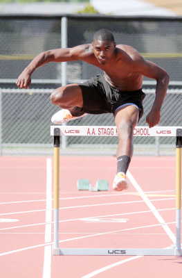 Senior Andre Lindsey works on his hurdle technique at a practice.