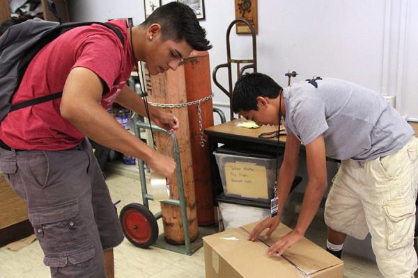 Sophomore Vincent Grayson and Junior Alex Rebultan pack up what’s left of the
Student Store inventory after the break in over the weekend of May 19.
