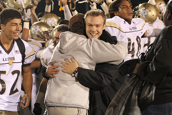 Assistant coaches Larry Johnson and Sean Kilduff embrace on the field after Stagg beat St. Mary’s. 
