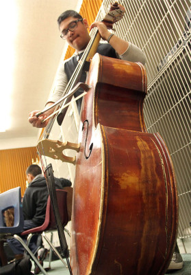 Freshman Javier Nunez must play carefully on a bass due to an irreparable crack. The instrument has gone through a previous repare with a similar crack in the same region.
