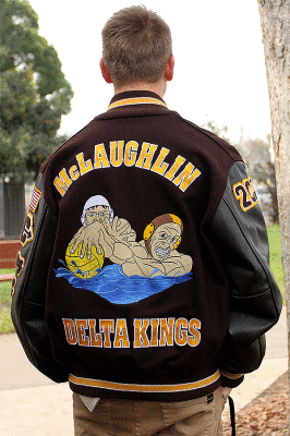 The Senior poses with his cutom jacket. The jacket has patches from each sport that he participated in. 