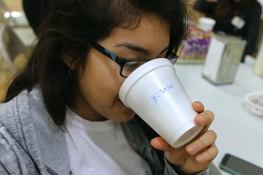 Senior Jessica Gonzalez takes a drink of juice from the cup that tells her what time she can leave. 