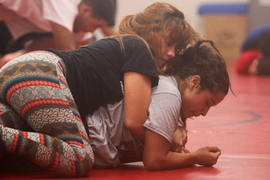 Senior Zariah Gonzales practices with her teammate, senior Alisha Hernandez.