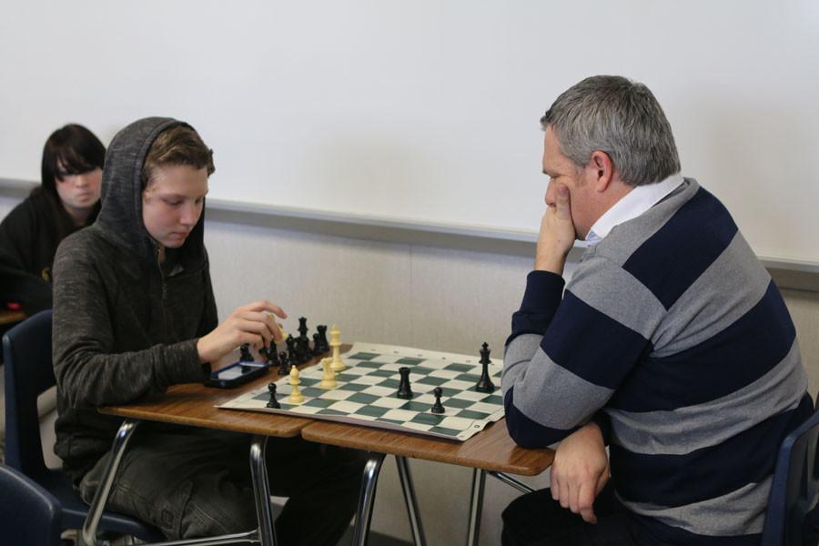English teacher Martin Bagnasco plays chess with a Chess Club member.