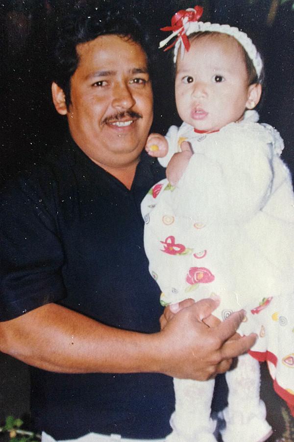 Jenifer’s father holds her, as the family celebrates her second birthday, in Mexico. 