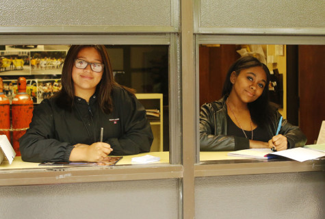 Corrina Rivera and Gabrielle Wallace work in the student store at lunch.