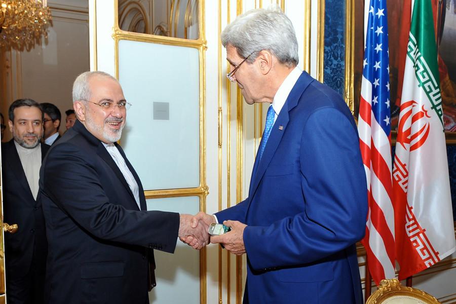 U.S. Secretary of State John Kerry shakes hands with Iranian Foreign Minister Mohammad Javad Zarif as he arrives at a hotel in Vienna, Austria, on July 14, 2014, for a second day of meetings about the future of his countrys nuclear program.