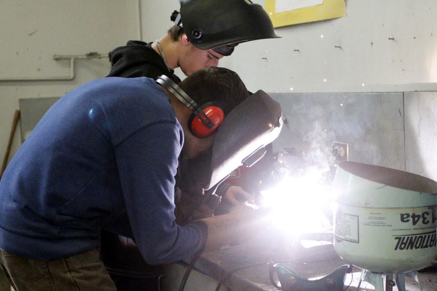 Jaymes York-Eck and Alejandro Alvarez work together welding. 