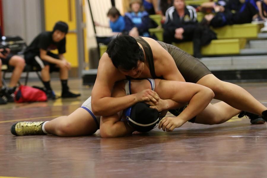 Senior Alejandro Figueroa wraps up his opponent and holds him down. 