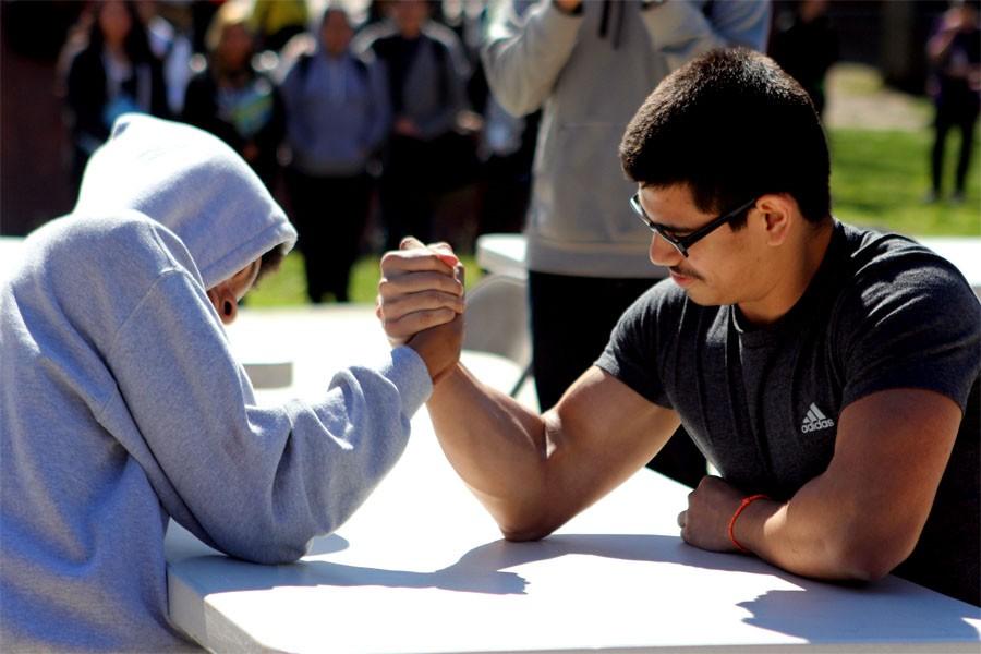 Luis Valenzuela leads the arm wrestling competition, losing to an IEP student. 