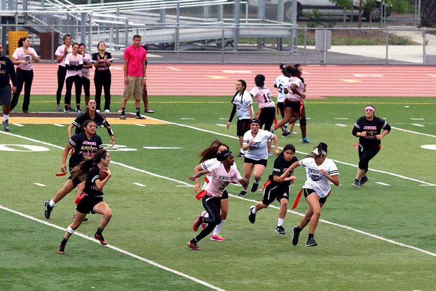 Senior Alexis Villagomez, runs to try and push the other players out of the way to stop Chavez quarterback from making a touchdown.