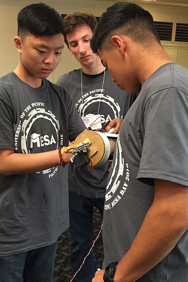 Sophomores Kevin Phan and Roberto Torres modify their prosthetic arm after the first trial of competition. In the end, they placed first overall and will move on to the regional round on April 30.