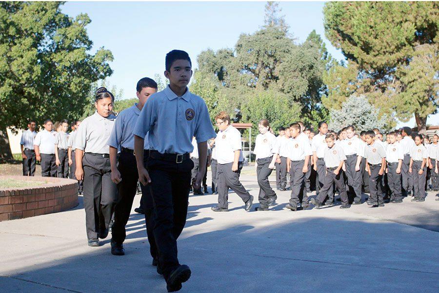 Cadets begin to march to their classrooms as Ben Torres, an officer, gives directions. They march daily on around the football field.