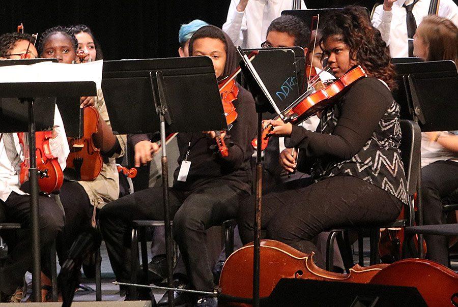 Kochia Anderson, senior, plays her instrument as Orchestra opens up their show.