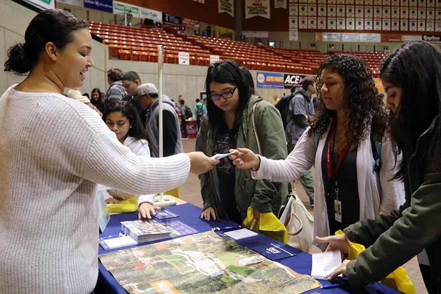 Juniors Bryanna Rodriguez and Shakira Rivera turn in a form asking for more information from Mills College.