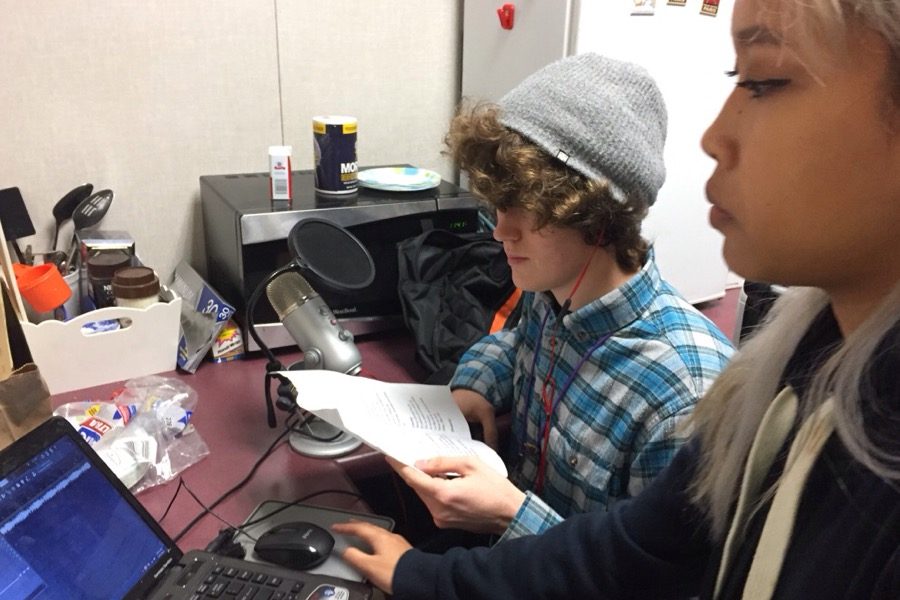Seniors Jessica Eth and Alexander Qualls record their voices with their microphone and laptop in a back room for a French verison of Were All In This Together from High School Musical. 
