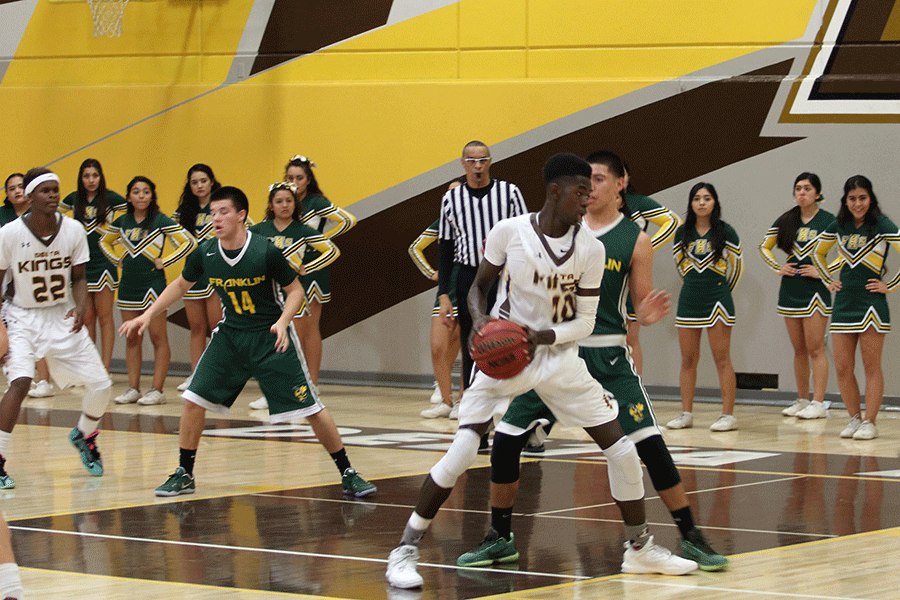 Junior Kaleb Carter scouts out other teammates to pass the ball to in order to score a point against Franklin High School. They won against Franklin which left them 4-2 in league.