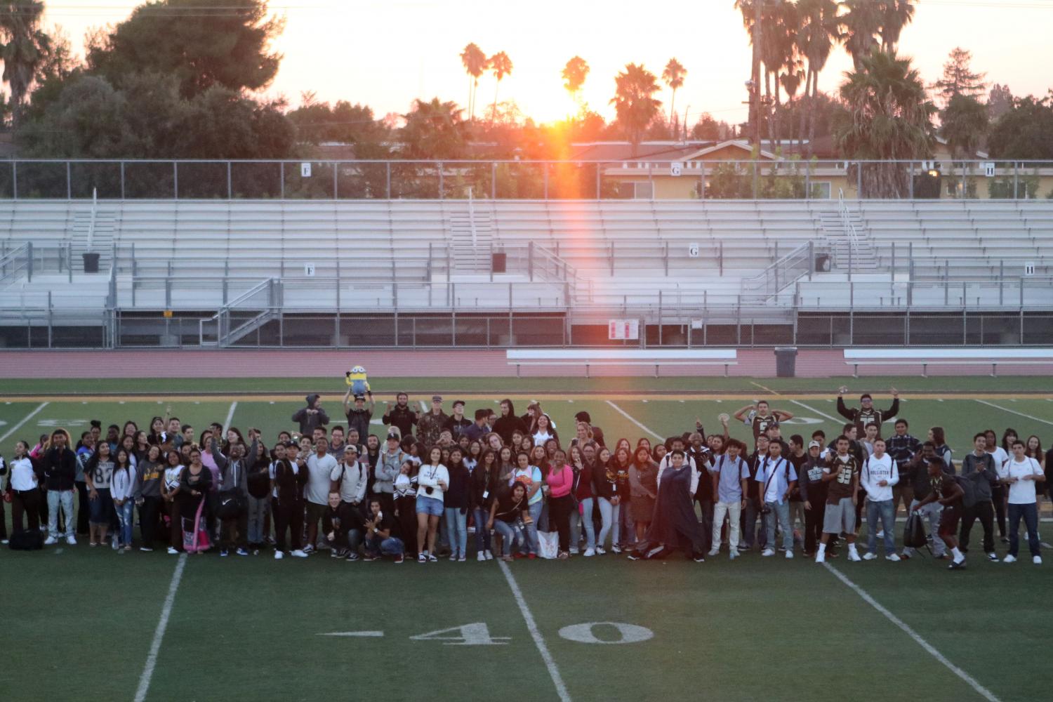 The class of 2018 groups together to take a picture with the sunrise.