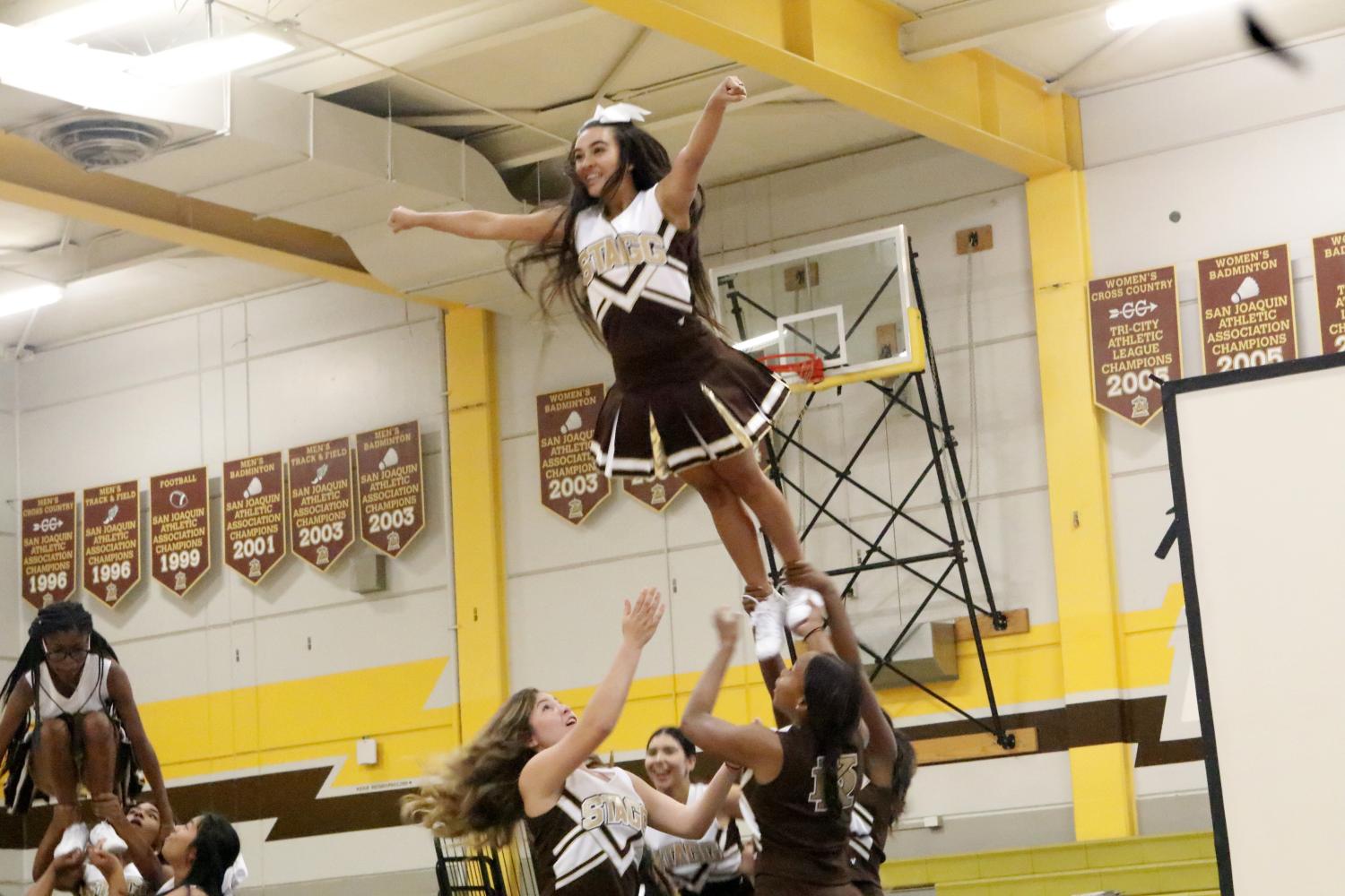 Alyzea Deputron is doing a super stunt during the cheer performance. 