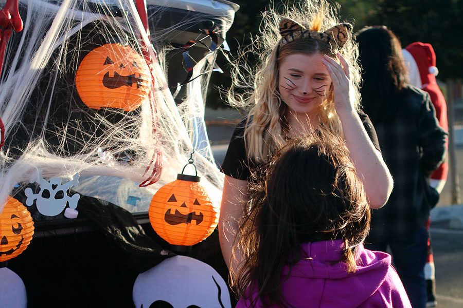 Calderon greets children with a smile as she handed them candy and wished them a happy Halloween.