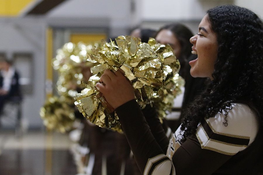 Senior Tressa Brown performs cheer as the varsity basketball game starts. 