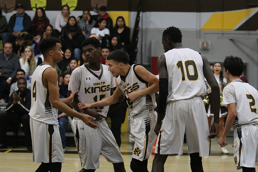 During the Jan. 17 game against Franklin, the first league game of the season, junior Esteban Rivera (right) is being helped back on his feet by teammates senior Jahbar Beard (left) and junior Kenyon Pierce (middle) after falling from blocking an opponent. Stagg won, 65-40.