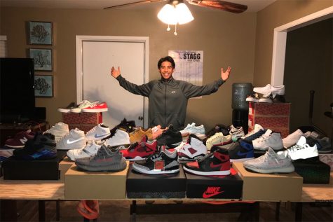 Michael Herrera, a senior, poses with his collection of shoes that he keeps at home. 