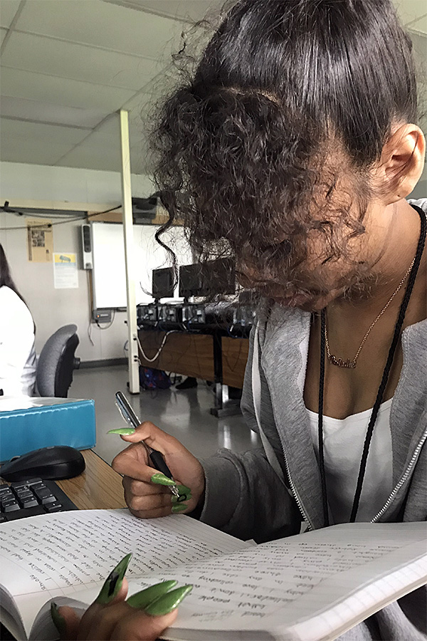 Junior Denise Morando goes over which pieces of writing she wants to submit to the Literary Magazine for publication. One of her writings titled “I Protest,” made it to the book which captured the day of the unplanned protest.