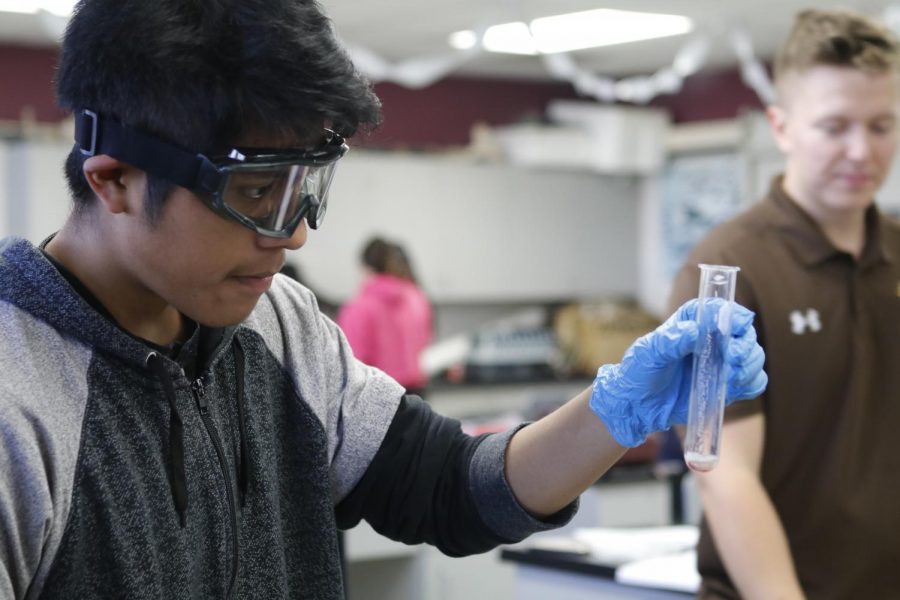 Senior Carlos Felipe is examining his test tube to see what went wrong with his reaction.