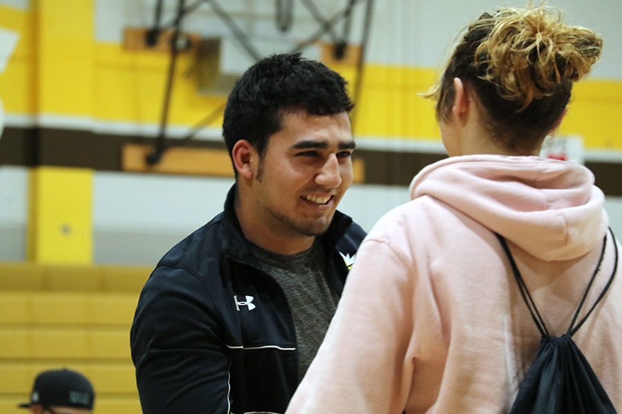Assistant wrestling coach Miguel  Coyt gives Freshman Katalina Danforth her most improved player award.