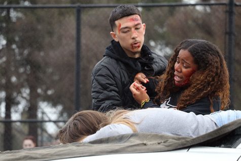 Seniors Enekeyo Sakata and Tenyiah Washington, two of the actors that were involved in the car crash, struggle to wake their friend Marissa Pimentel up. Pimentel was pronounced dead on the scene.