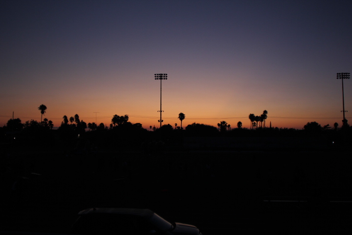 Sun rising over football stadium