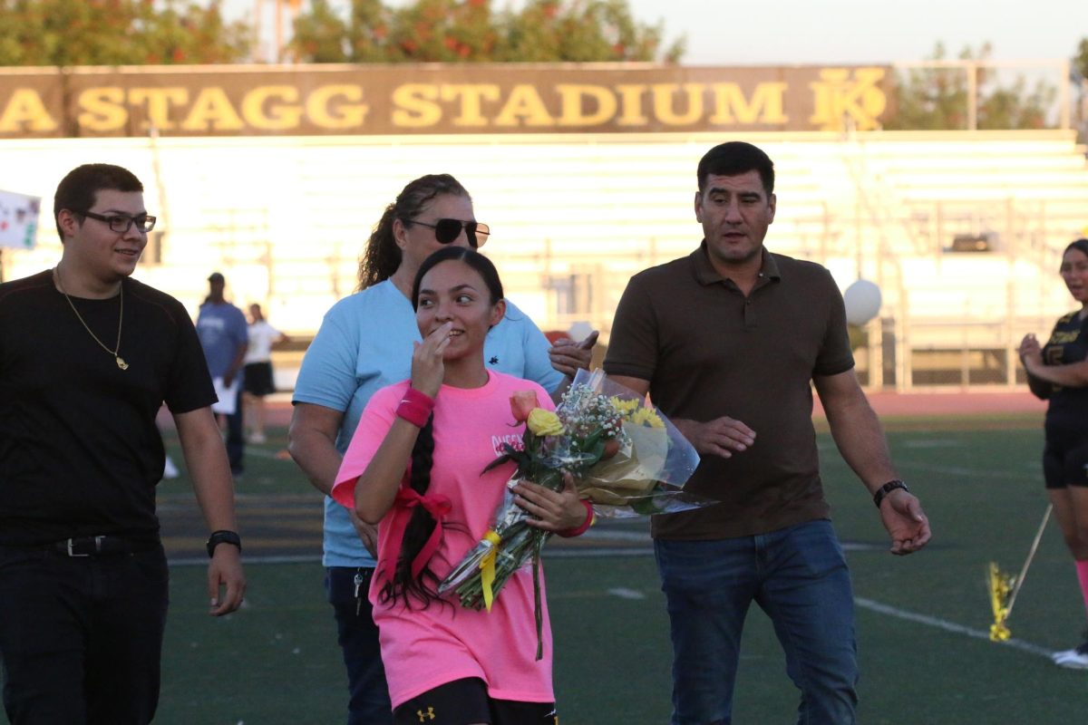 Senior Angel Avila filled with joy after receiving flowers from her teammates and family