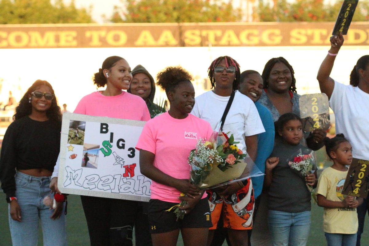 Senior Jameelah Pharms standing with her friends and family