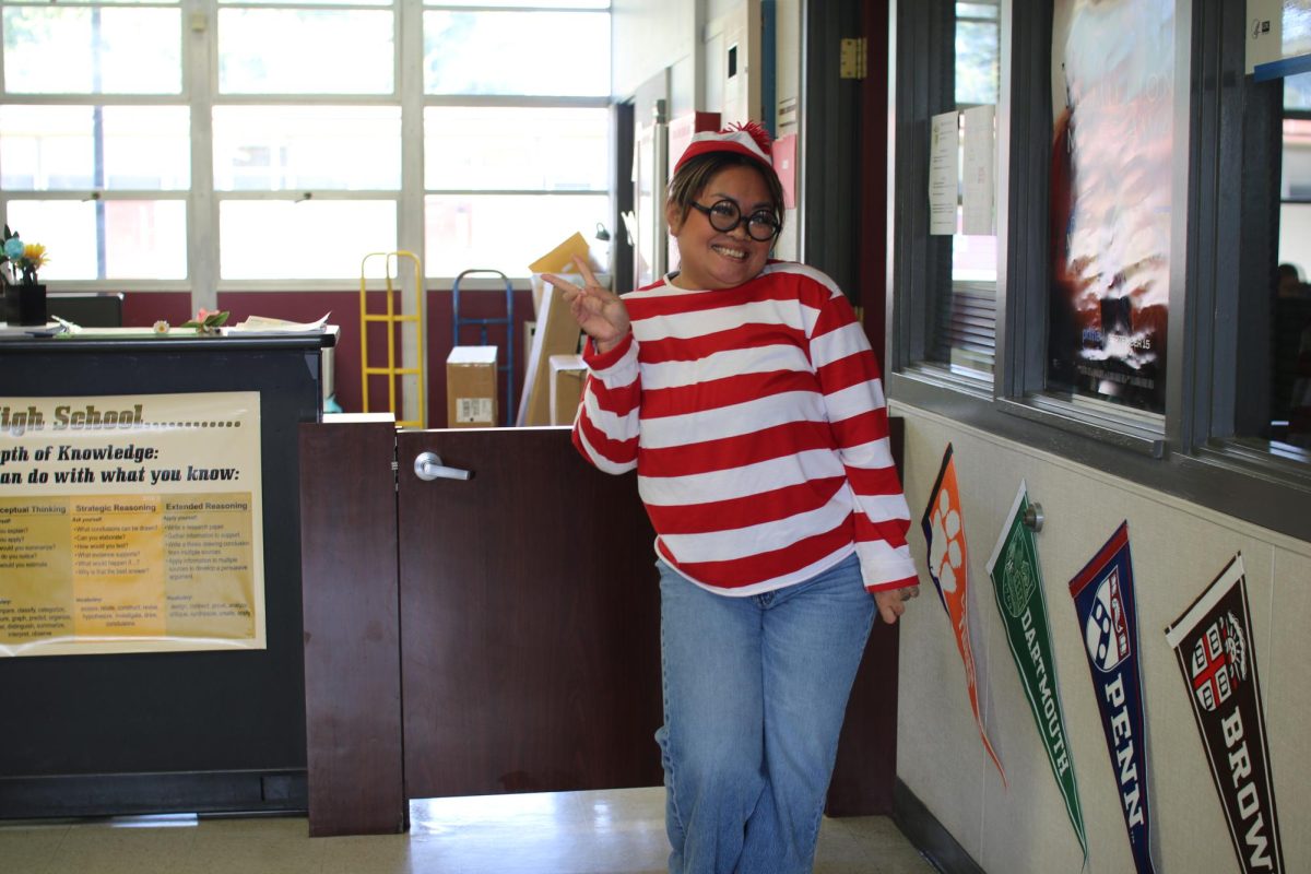 School+Secretary%2C+Lisa+Sounn+dressed+as+Waldo+from+the+famous+book+series+Wheres+Waldo+for+spirit+week.+%28Madysin+Camillo+%2F+Stagg+Online%29