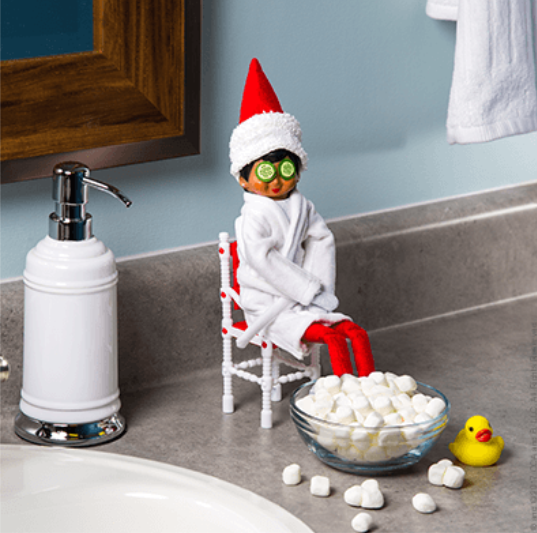 Elf On The Shelf sits with its legs placed in marshmallow bowl. Courtesy of Google