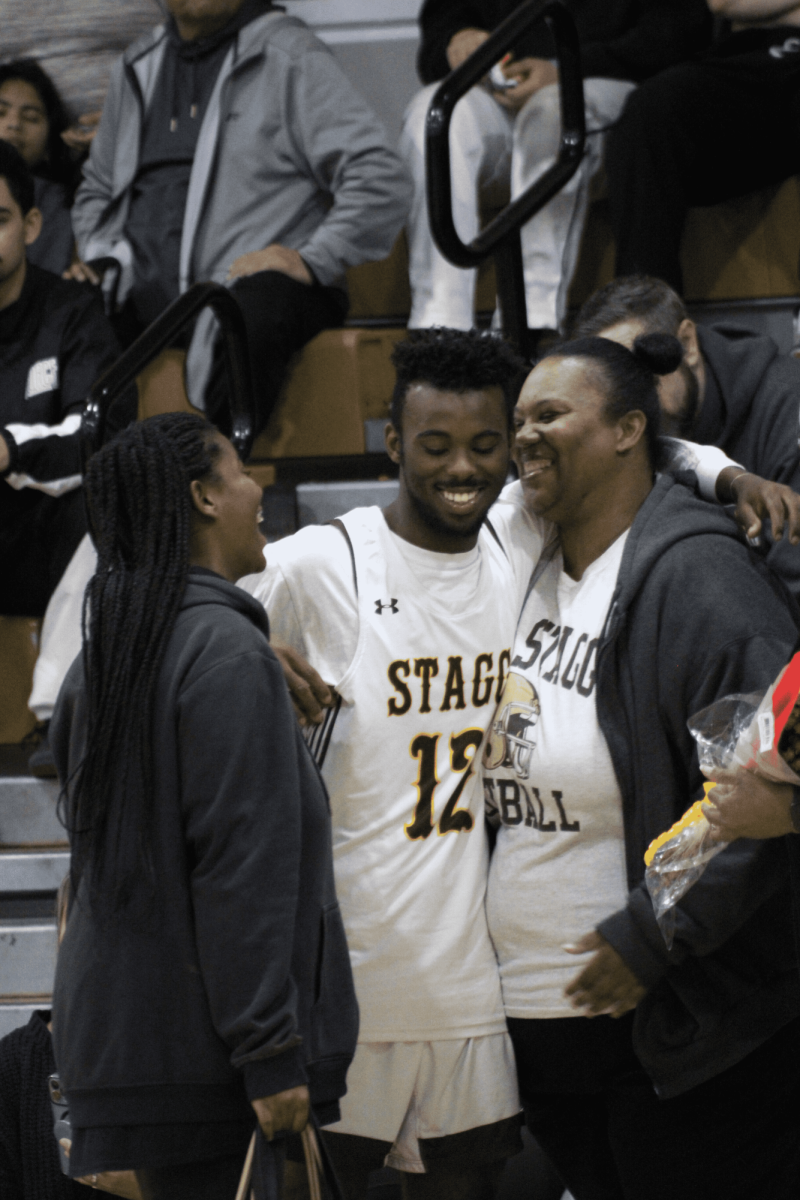 Senior Dontrell Wesson hugs his family members after being called up during the Senior Night presentation in the Stagg gymnasium. Wesson claims his mother has attended every single one of his games. 
