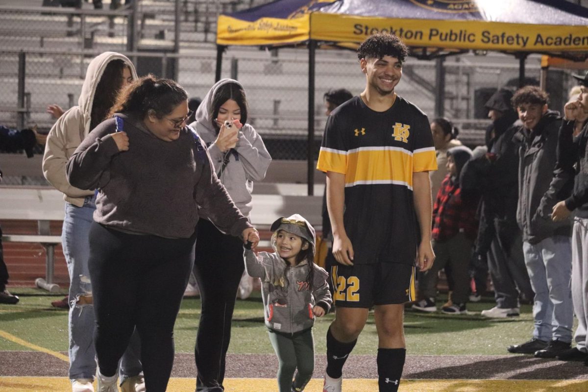 Isaiah Richardson walks through celebrating families with mother, girlfriend, and sisters. Richardson has been playing since 7th grade and plays striker. 
