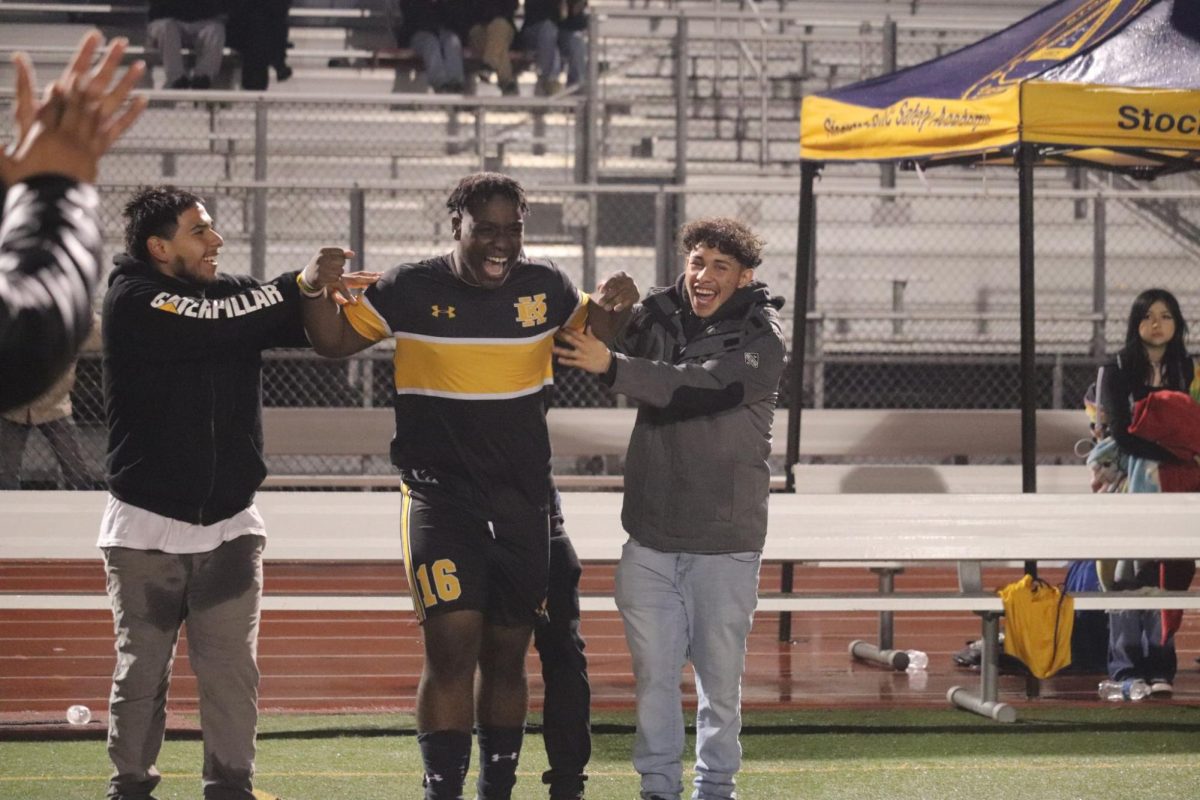  Aloysis Tih jumps for joy as he celebrates win against Linden with friends Ramon (left) and Juan (right). Tih plays right back and striker.
