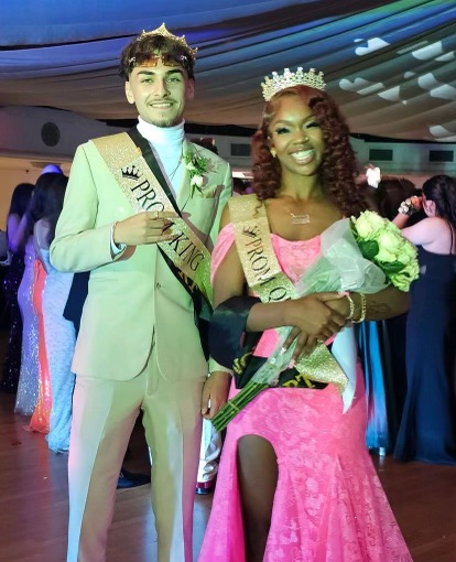 (Prom King Emiliano Ayala and Prom Queen Kamari Wallace stand side by side with bright smiles on their faces wearing their crowns and sashes. Wallace was given flowers during the announcement. Picture from @aastagghigh on Instagram)
