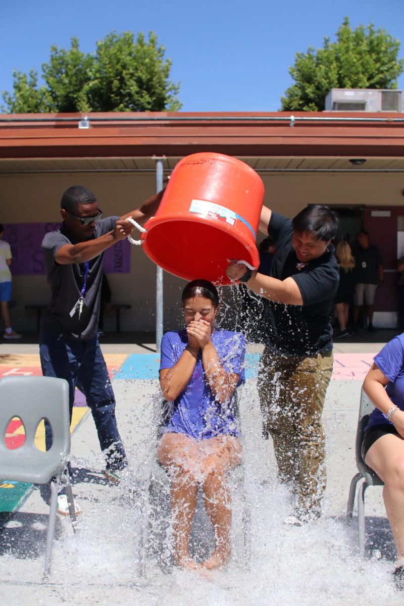 Danna Galindo gets soaked by the 2025 class advisor Mr. Sandidad and Mr.Lavell on the first day of the event.  She was one of the first to be soaked this day.