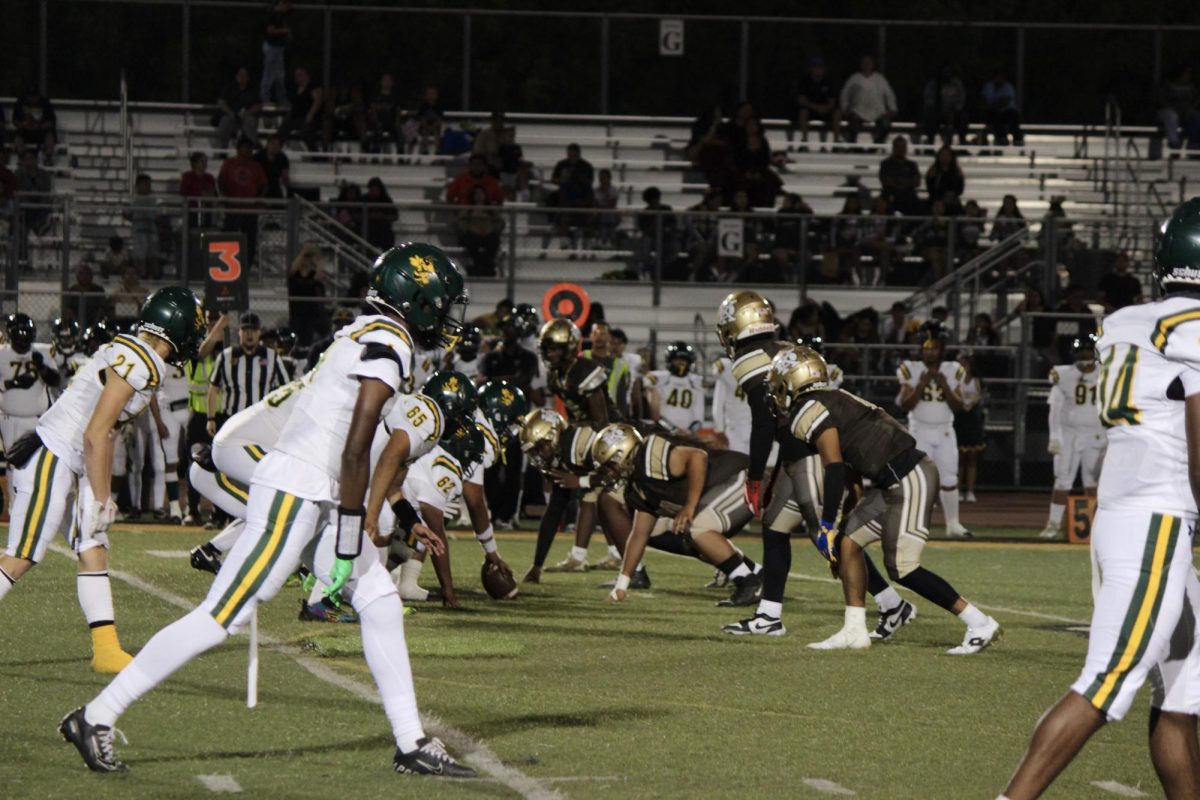 Franklin's Varsity football team positioned to snap the ball, while Stagg's defensive line locked onto their opponents. Franklin made it 20 yards down the field before being stopped by the Staggs defense.