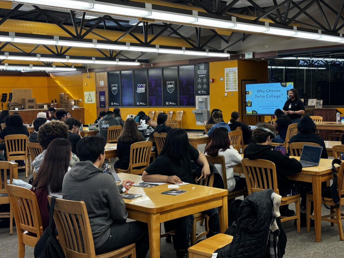 Students listen during the Delta College presentation in Stagg’s library as Michale Ferroni lists an abundance of reasons why students should consider attending college