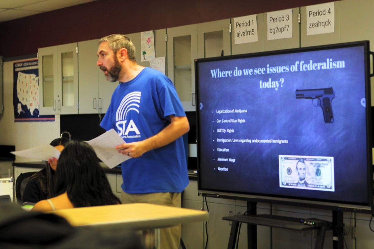 AP Government teacher Christpher Rothrock gives the rules for the scavenger hunt. Rothrock hopes the students understand the issues present today that affect them on a deeper level.