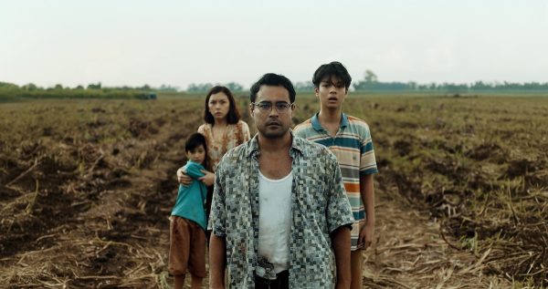 Francis looks at a group of zombies rising from the fields with ex-wife Iris and sons Lucas (left) and Joshua. After this scene in the middle of the movie, Francis' traumatic past starts affecting him. (Netflix)