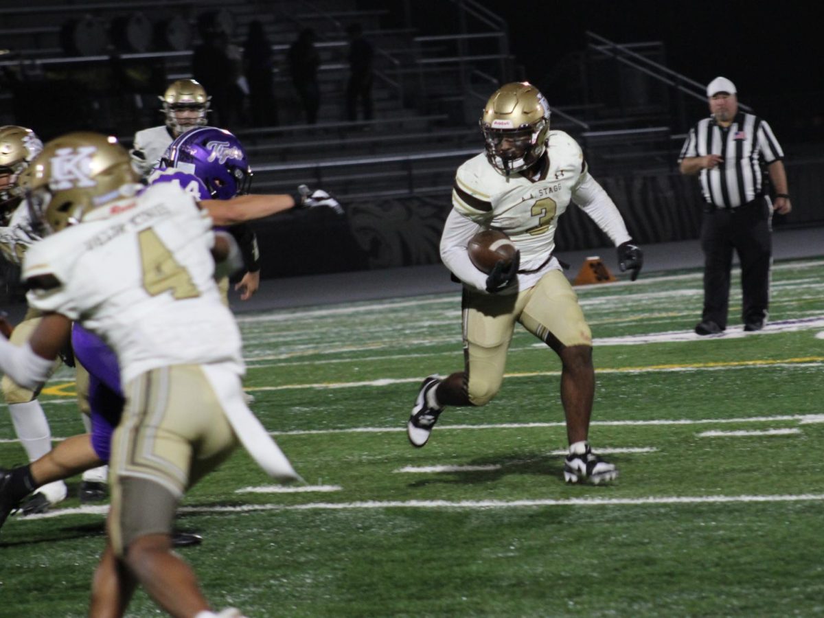 Benton runs past the Linden defenders with ball in hand past the 40 yard line. In this game Benton scored a touchdown and led in total yards and the all purpose yards categories.