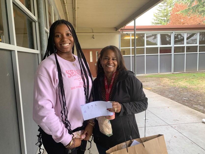 Nicole Churchill (right) and Savanna Dupart deliver their Christmas grams to their designated customers. This was BSU’s last day to deliver grams 