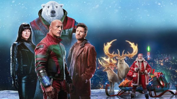 Callum played by Dwayne Johnson, Jack played by Chris Evans ,Zoe played by Lucy Liu pose on a poster for the movie. These three are the main characters who are trying to find Santa.