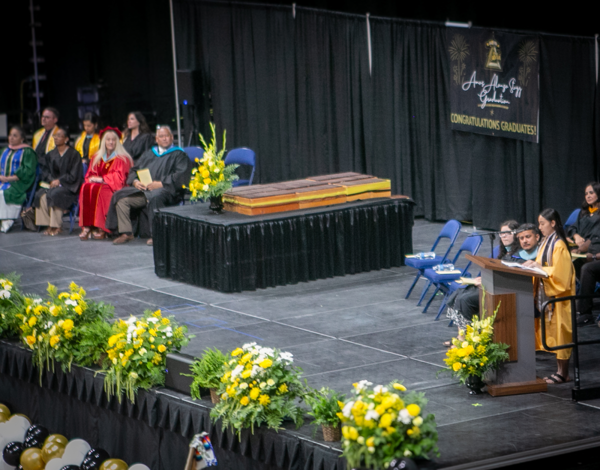 Graduating salutatorian Madalyn Choung-Sun standing at a pedestal, citing a speech. She expresses her gratitude towards her graduating class.